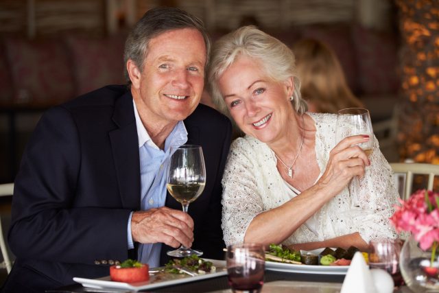 Senior Couple Enjoying Meal In Restaurant